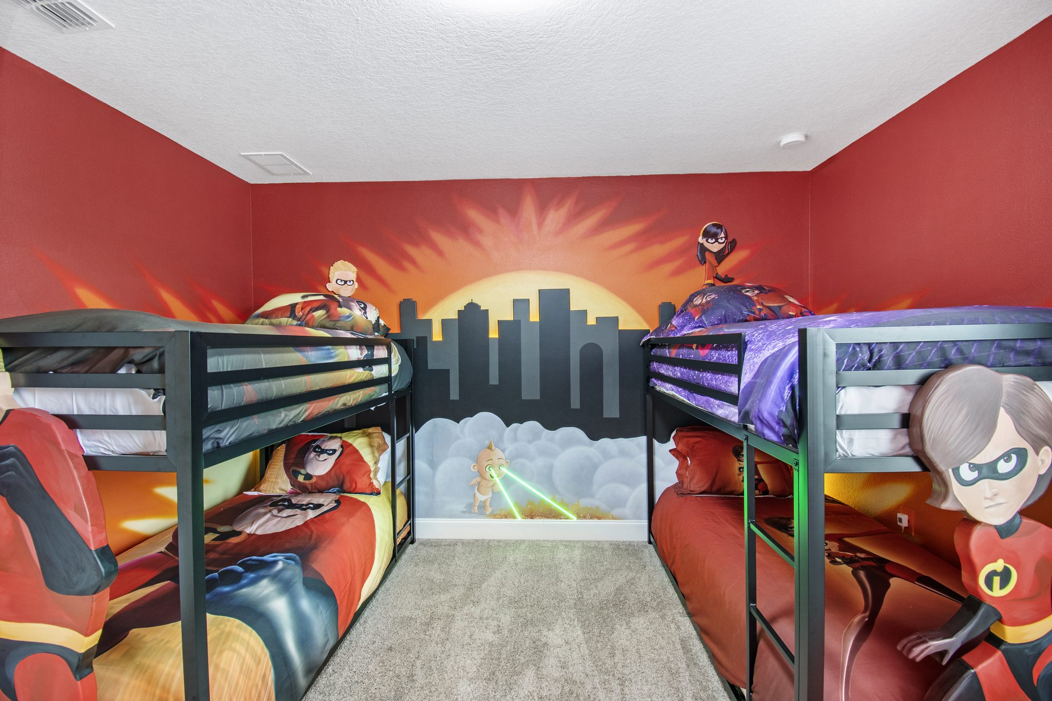 The Incredibles-themed bedroom with two twin-over-twin bunk beds and superhero m